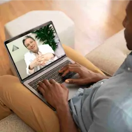 A man having a telehealth visit with a physician
