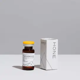A vial of injectable testosterone from Hone next to its box